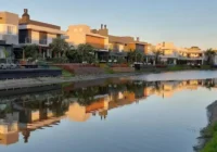 Casas luxuosas à beira do canal com reflexos dourados do entardecer — Malibu Beach Residence