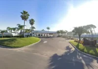 Entrada principal do condomínio Malibu Beach Residence com palmeiras